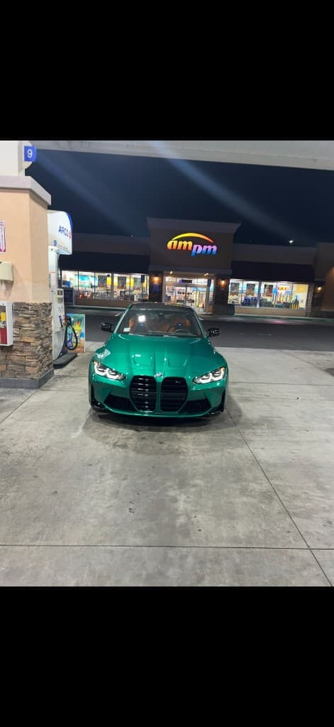Isle of Man Green BMW M at a gas station at night