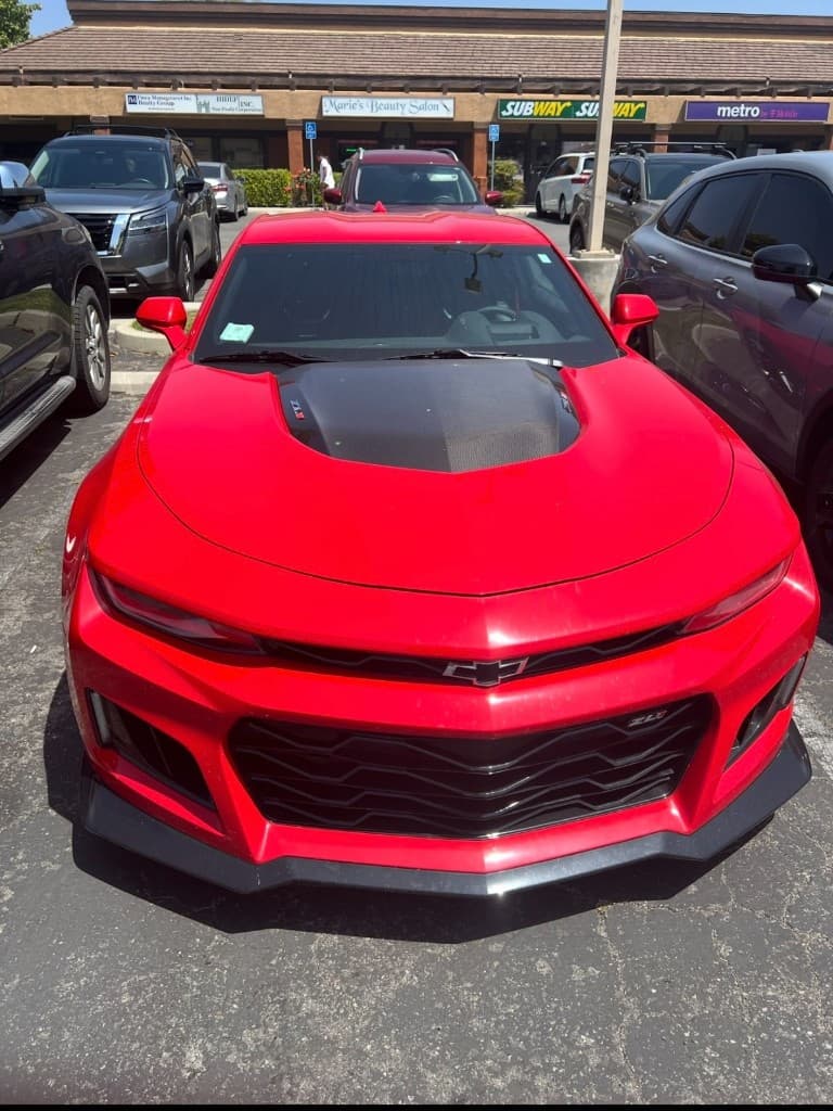 Red Chevrolet Camaro ZL1 front end in daylight